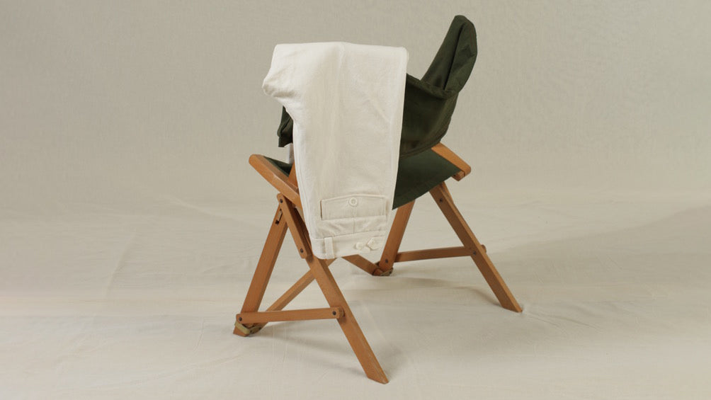 French vintage-inspired workwear pants on a vintage chair